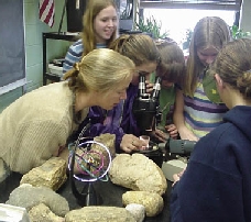 Photograph of middle school students using a microscope